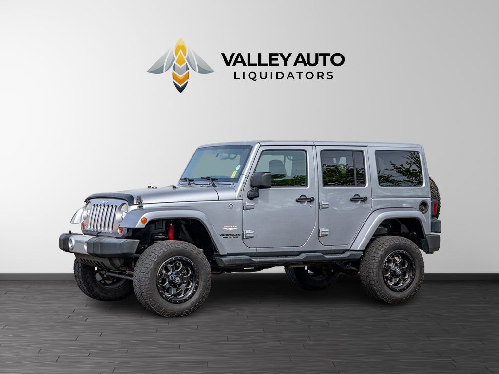 2013 Jeep Wrangler Unlimited Sahara in Silver — front three-quarter view